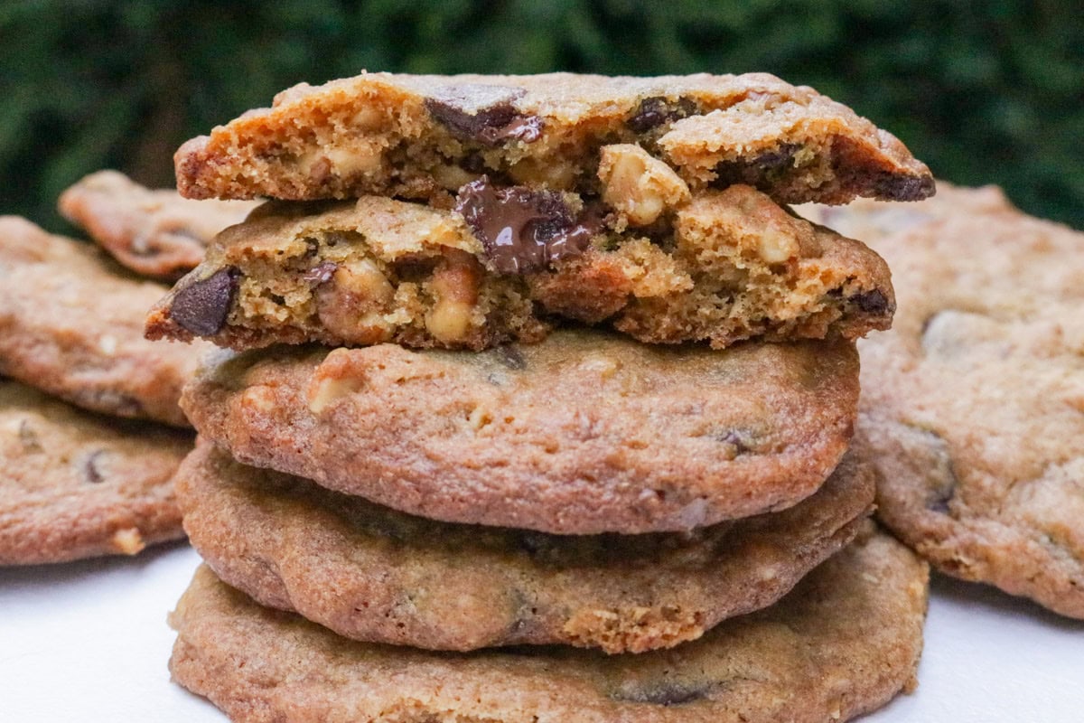 Two halves of a cookie on top of three whole cookies.