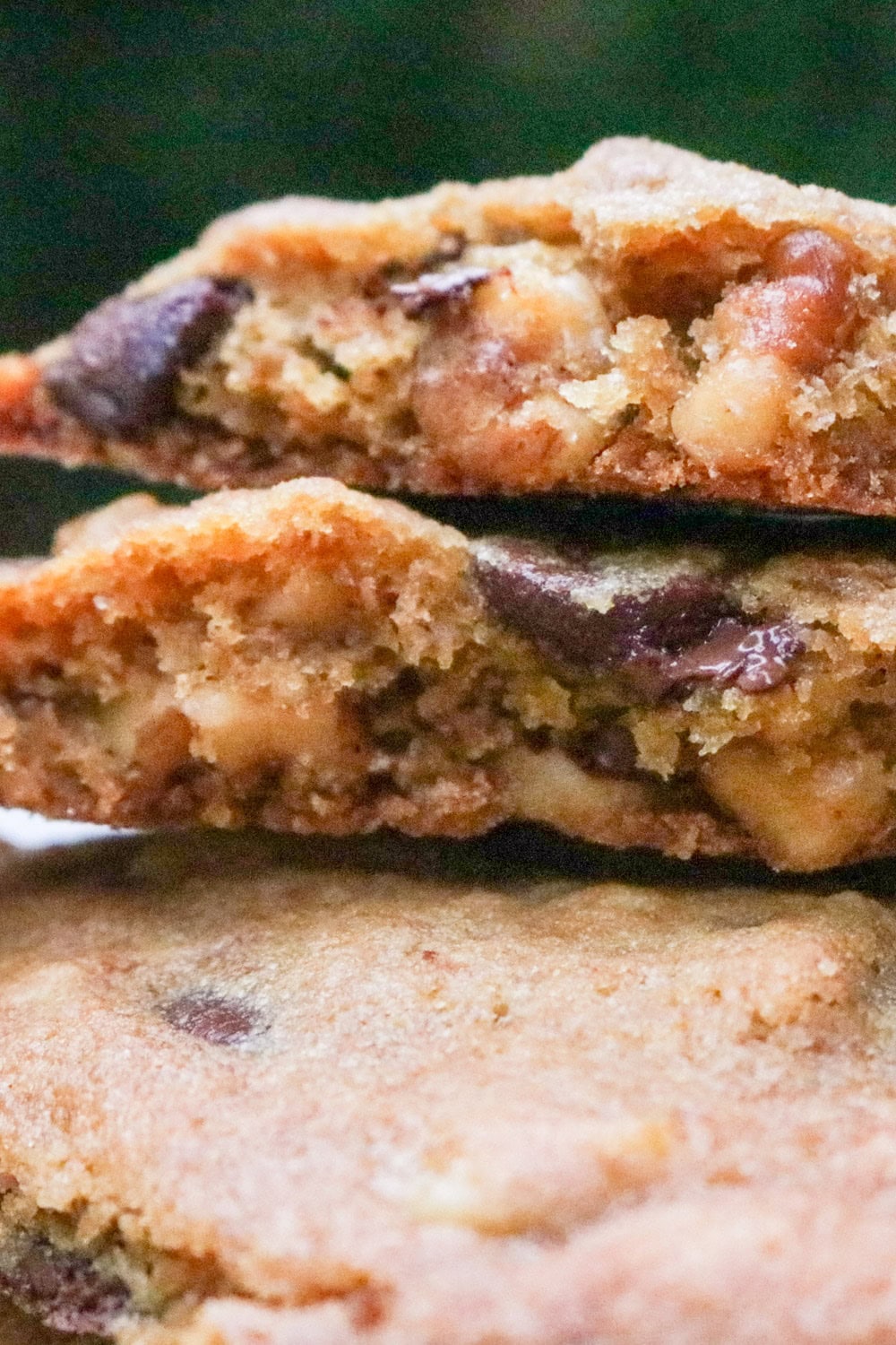 Two halves of a cookie on top of three whole cookies.