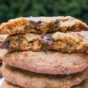 Two halves of a cookie on top of three whole cookies.