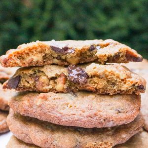 Two halves of a cookie on top of three whole cookies.