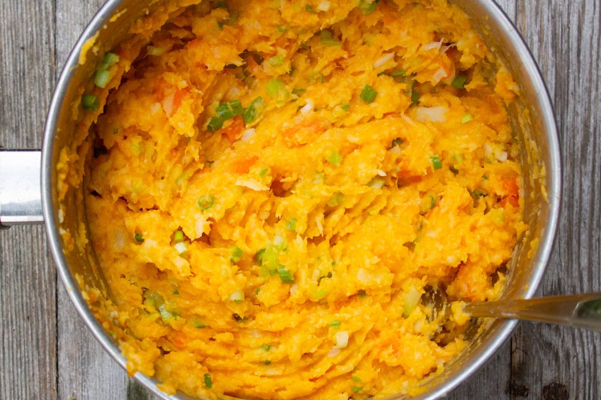 Root vegetable mash in pot.