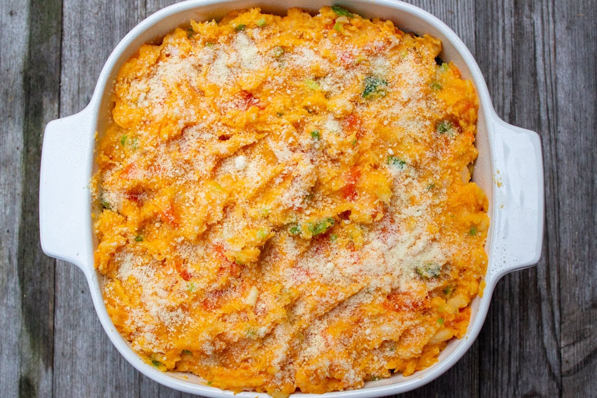 Root vegetable mash on top of filling in casserole dish, unbaked.