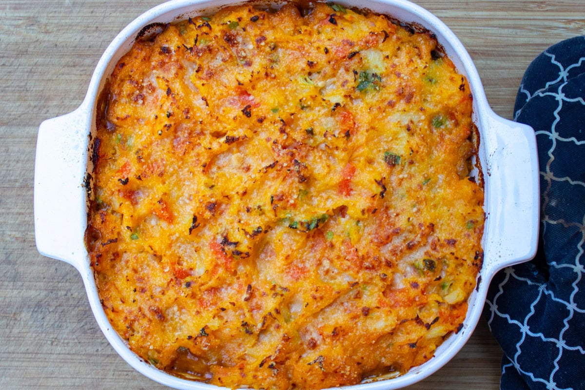 Baked shepherd's pie with root vegetable mash in casserole dish.