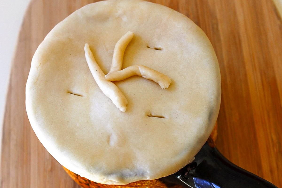 Unbaked chicken pot pie in individual dish.