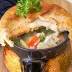 Chicken pot pie with crust broken open.