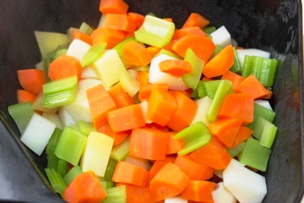 Blanched vegetables for pot pie in colander.