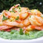 Sous vide shrimp over cauliflower spinach mash garnished with lemon zest, parsley and sweet chili sauce.