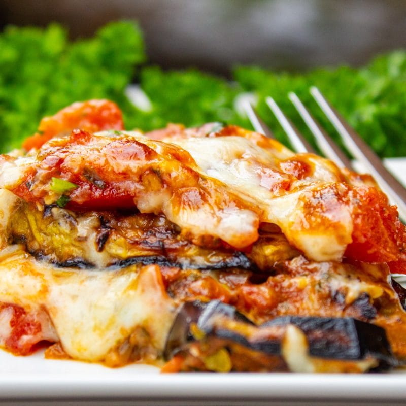 Piece of eggplant parmesan on plate.