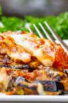 Piece of eggplant parmesan on plate.