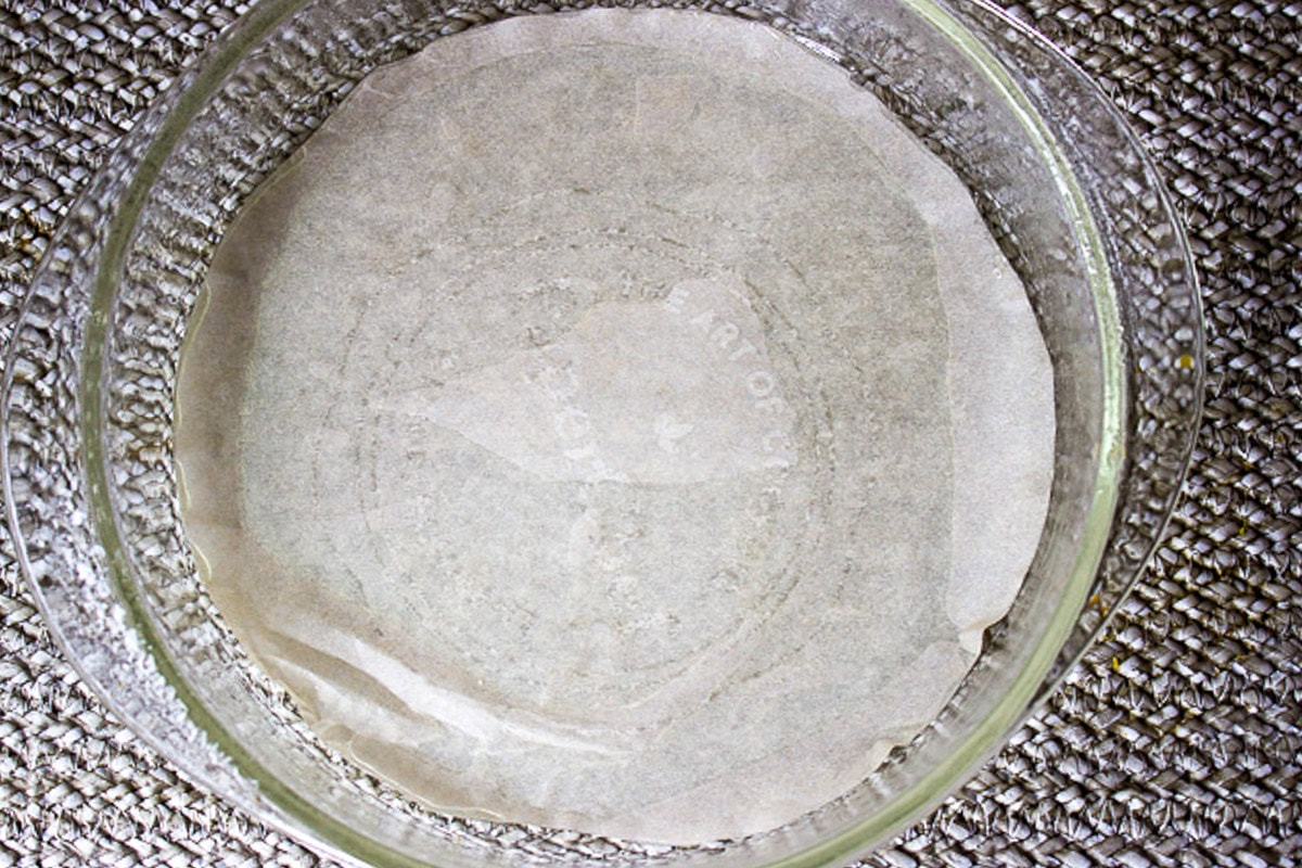 Parchment line bottom of round cake pan.