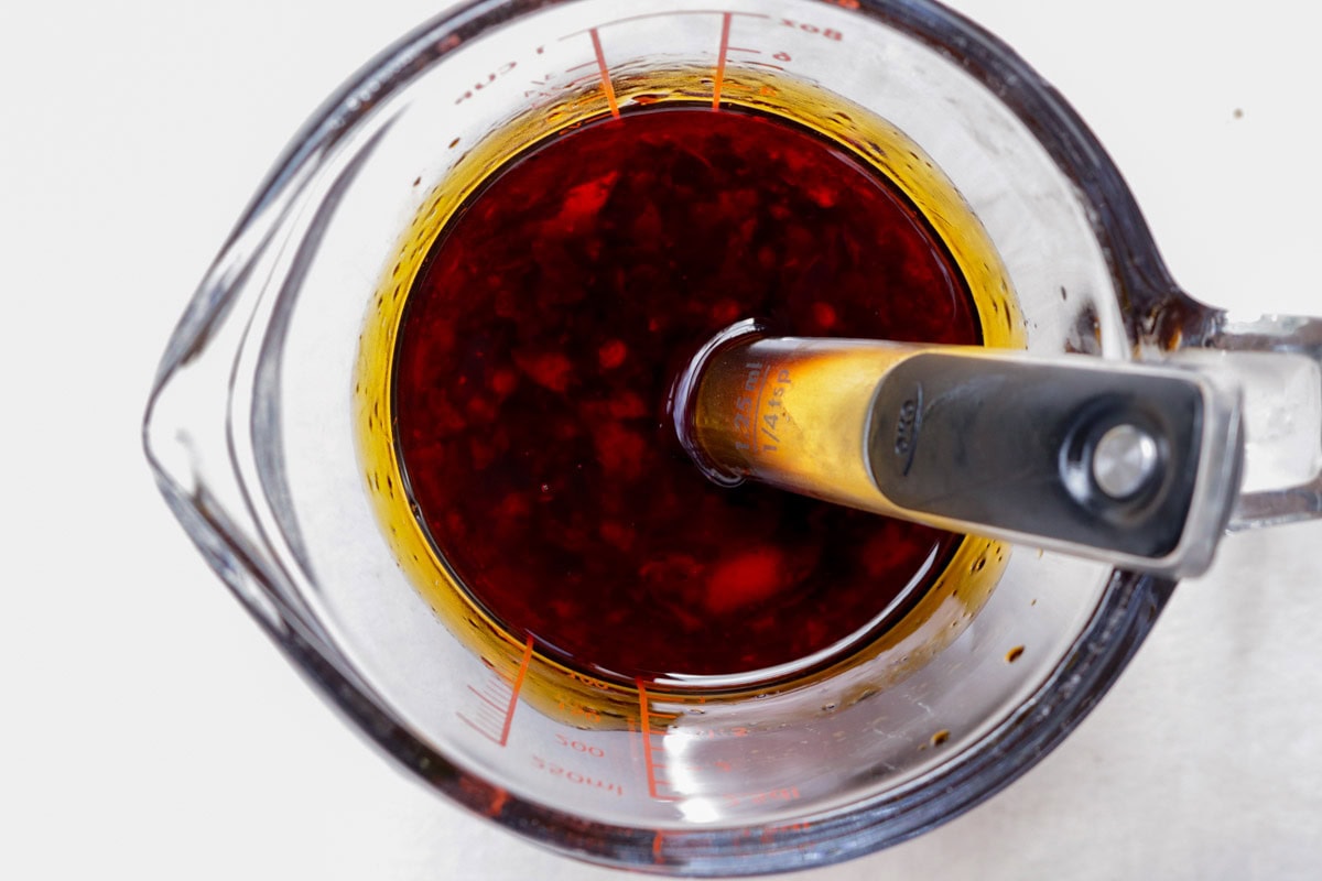 Sauce ingredients in a measuring cup on counter.