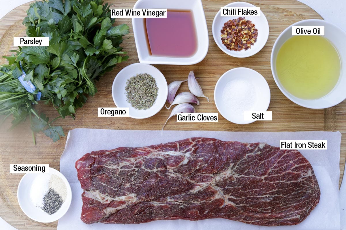 Flat iron steak, seasoning, parsley, red wine vinegar, chili flakes, oregano, salt, garlic cloves, olive oil.