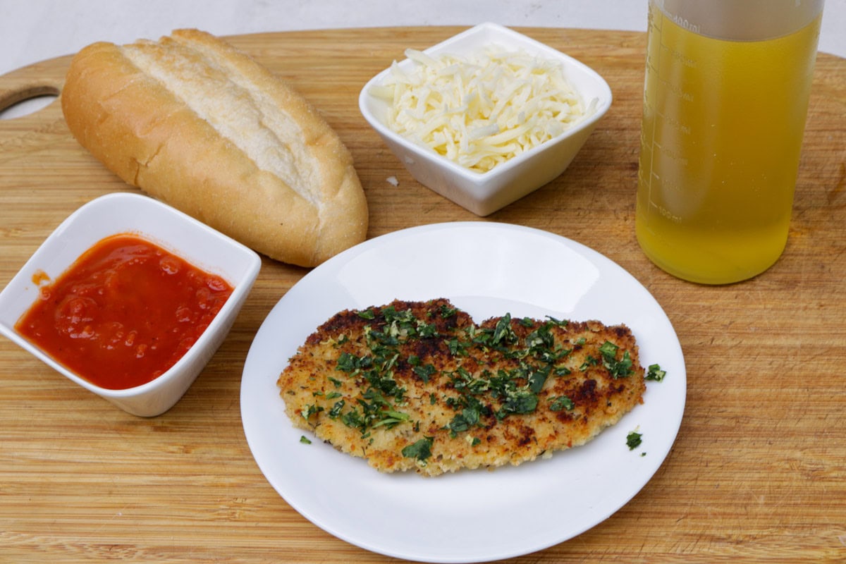 Chicken cutlet, bread roll, tomato sauce, mozzarella , olive oil.