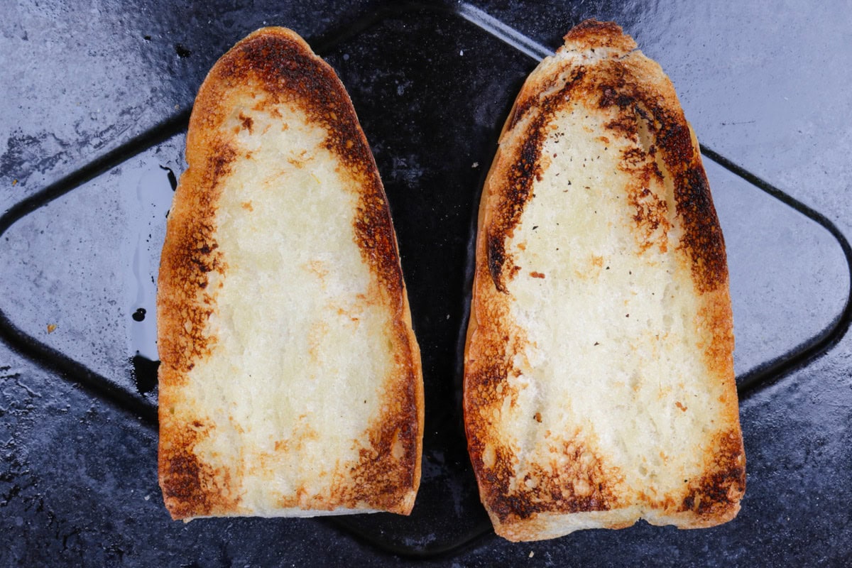 One roll split in half and toasted on baking tray.