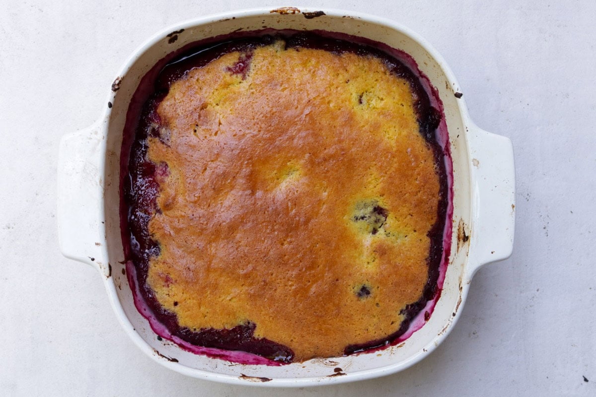 Baked berry cake in baking dish.