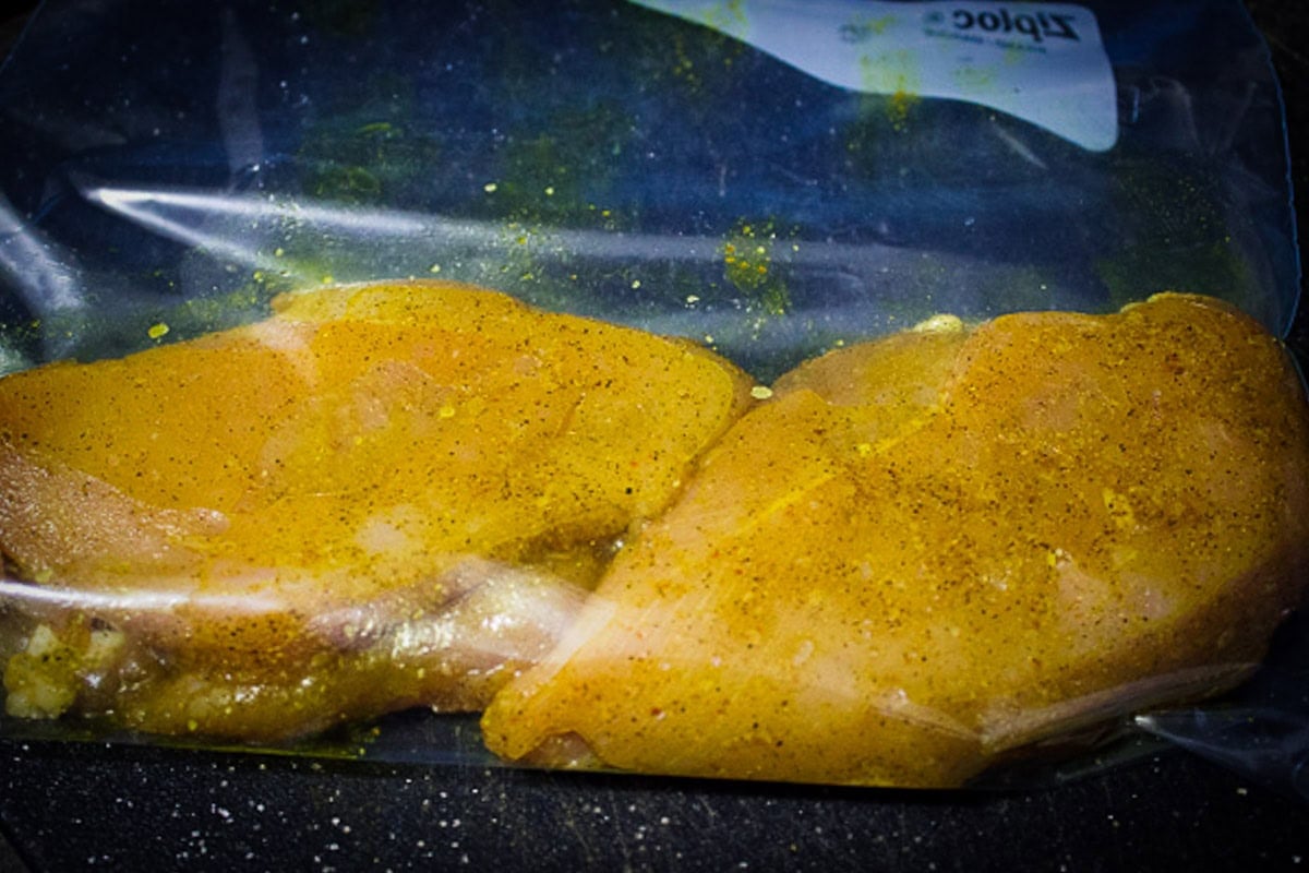 Seasoned chicken breasts in sous vide bag.