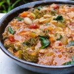 Kale, white bean and sausage soup in bowl.