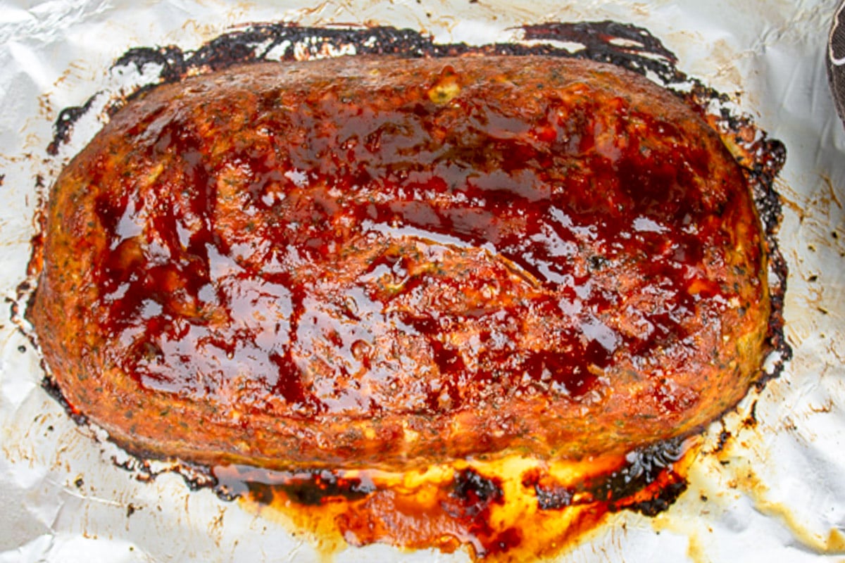 Baked glazed chicken meatloaf on pan.