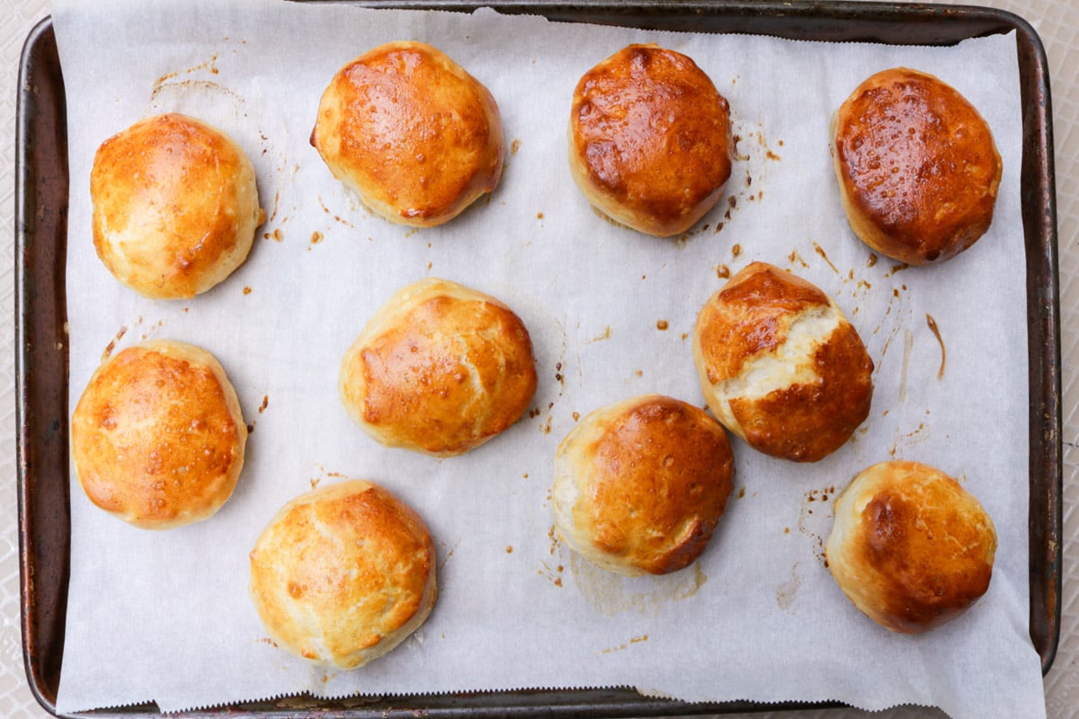 Baked biscuits on parchment lined baking sheet.