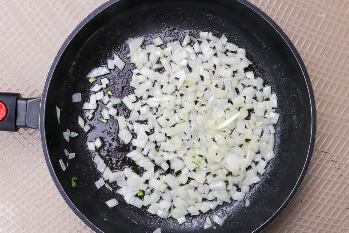 Sauteed chopped onions in a skillet.