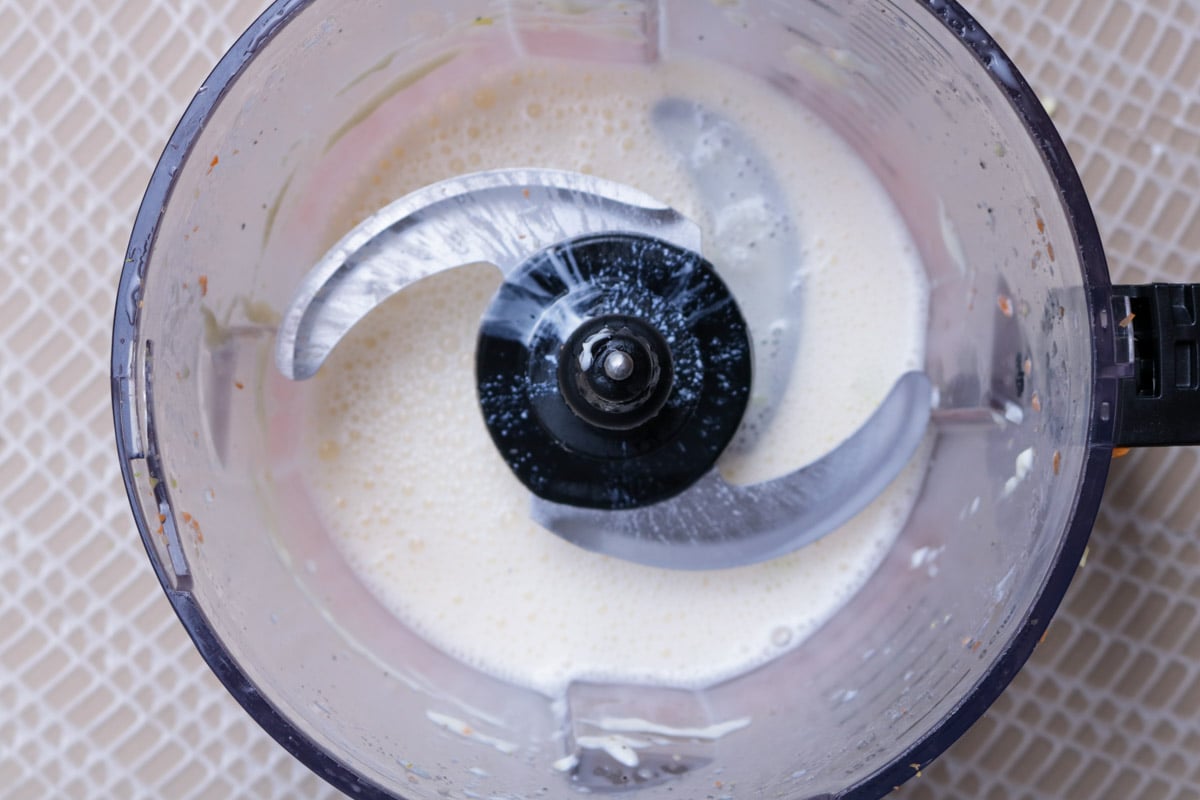 Coleslaw dressing in food processor bowl.
