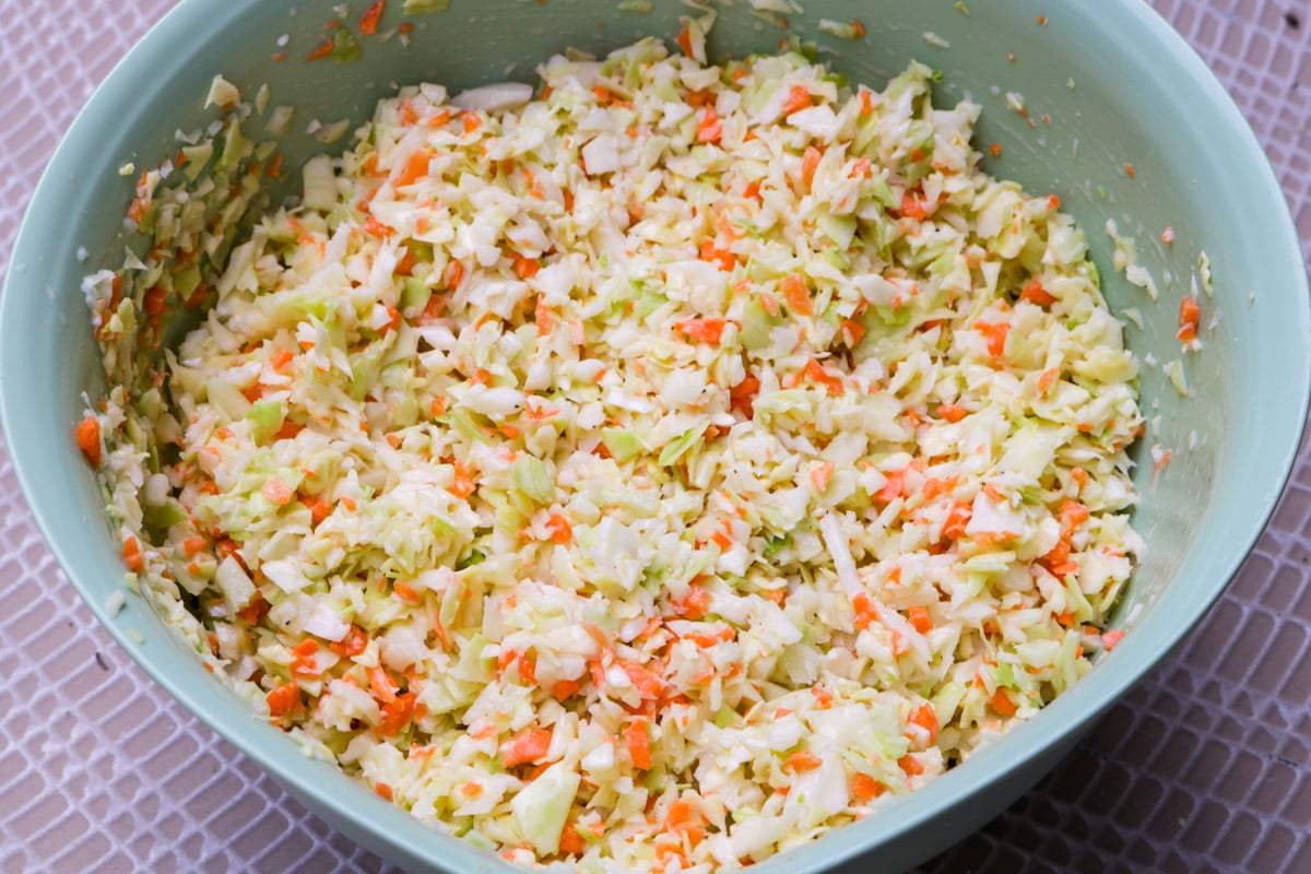 KFC cabbage in pale green mixing bowl.