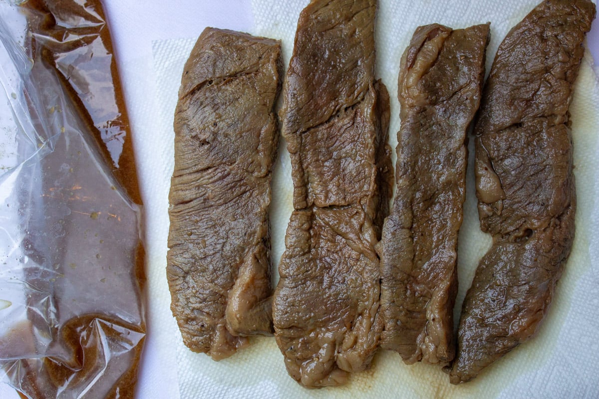 Strips of unglazed sous vide boneless short ribs on paper towels.