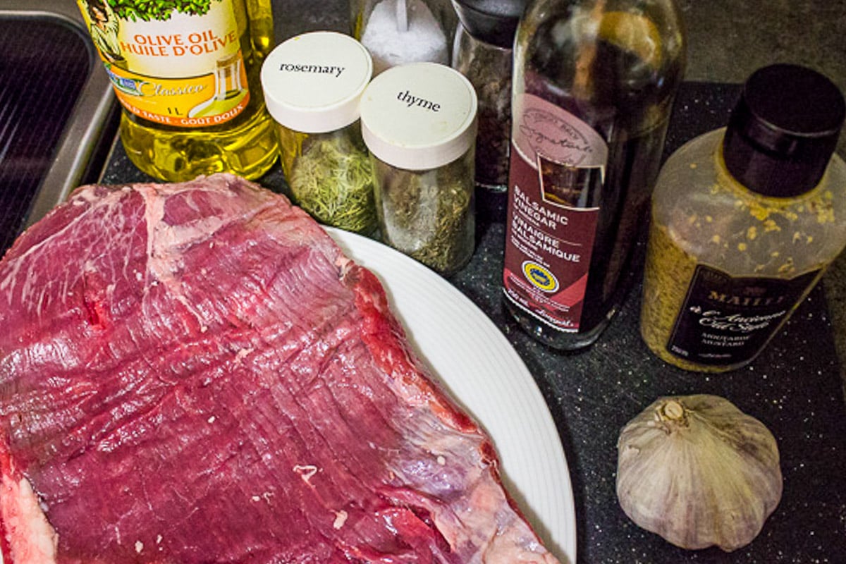Flank steak, balsamic vinegar, olive oil, dried thyme and rosemary, Dijon, fresh garlic,.
