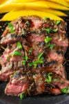 Slice flank steak on plate drizzled with glaze.