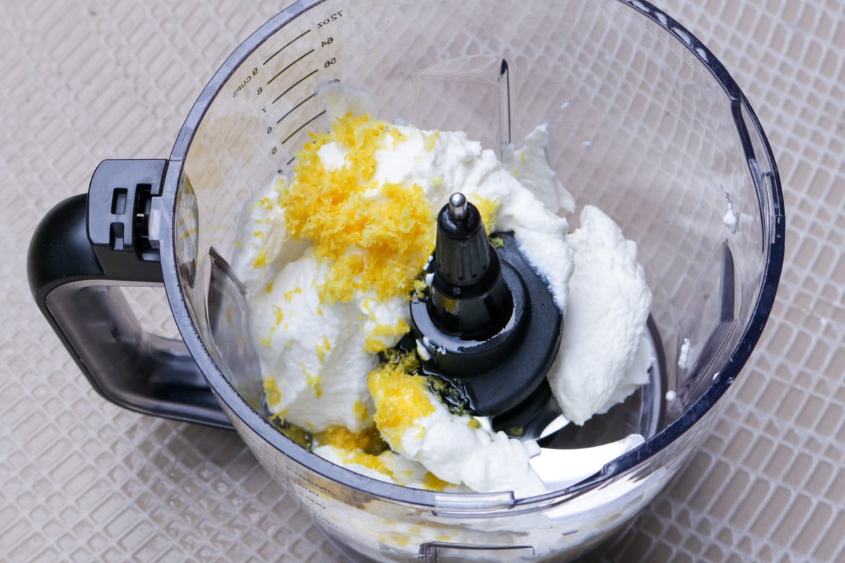 Ricotta, lemon zest, olive oil and salt in a food processor bowl,.