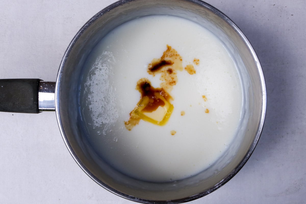 Pudding with butter and vanilla extract in a pot.