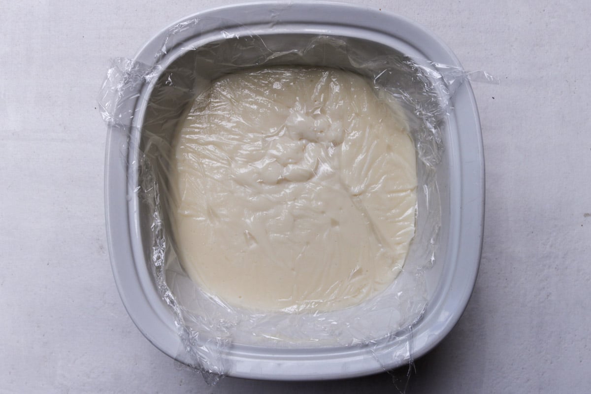 Pudding in casserole dish, covered with plastic wrap.