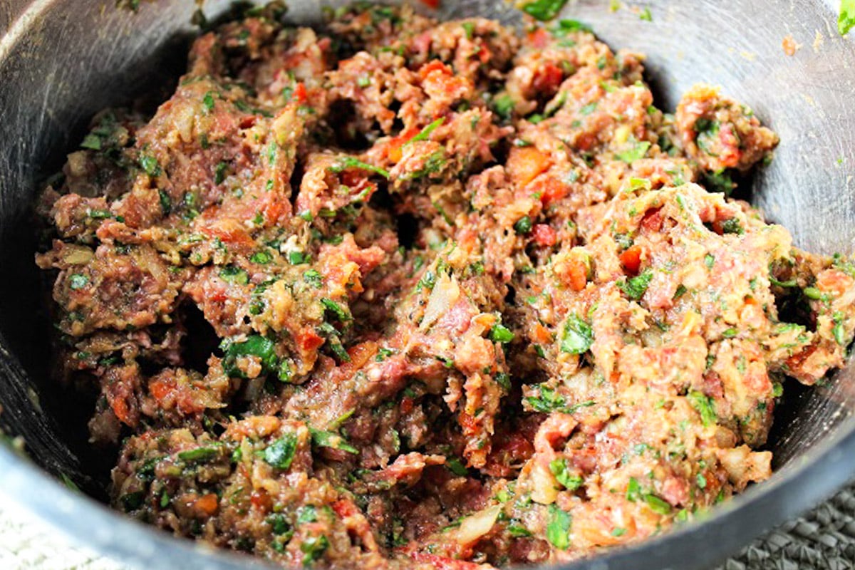Meat and vegetable mixture in mixing bowl.