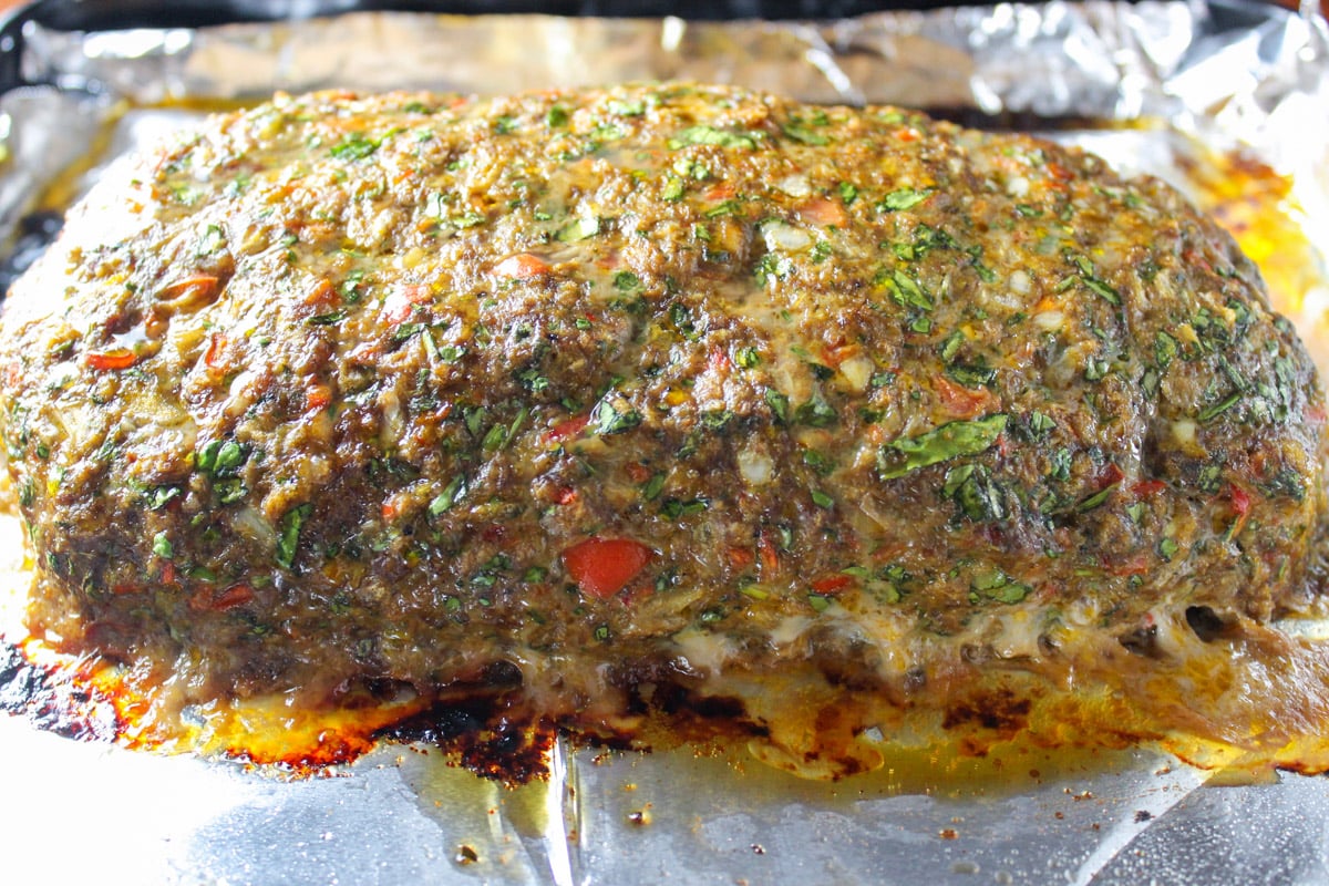 Cooked meatloaf on lined pan.