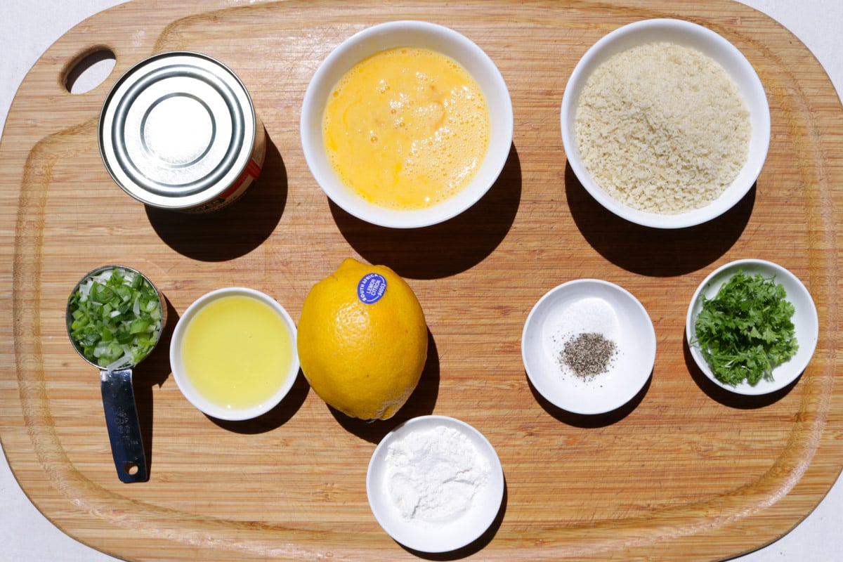 Can of salmon, beaten eggs, Panko, lemon, olive oil, chopped green onions, parsley, flour, salt & pepper.