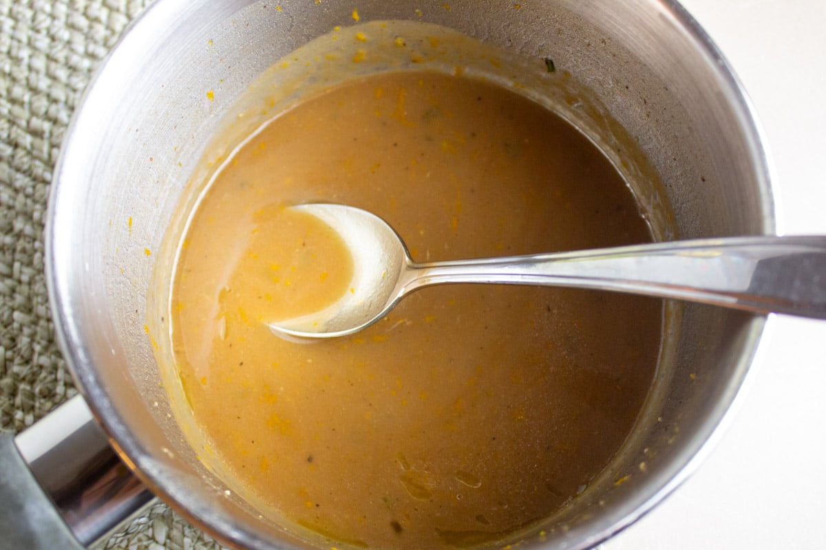 Orange balsamic maple dijon sauce in a pot.