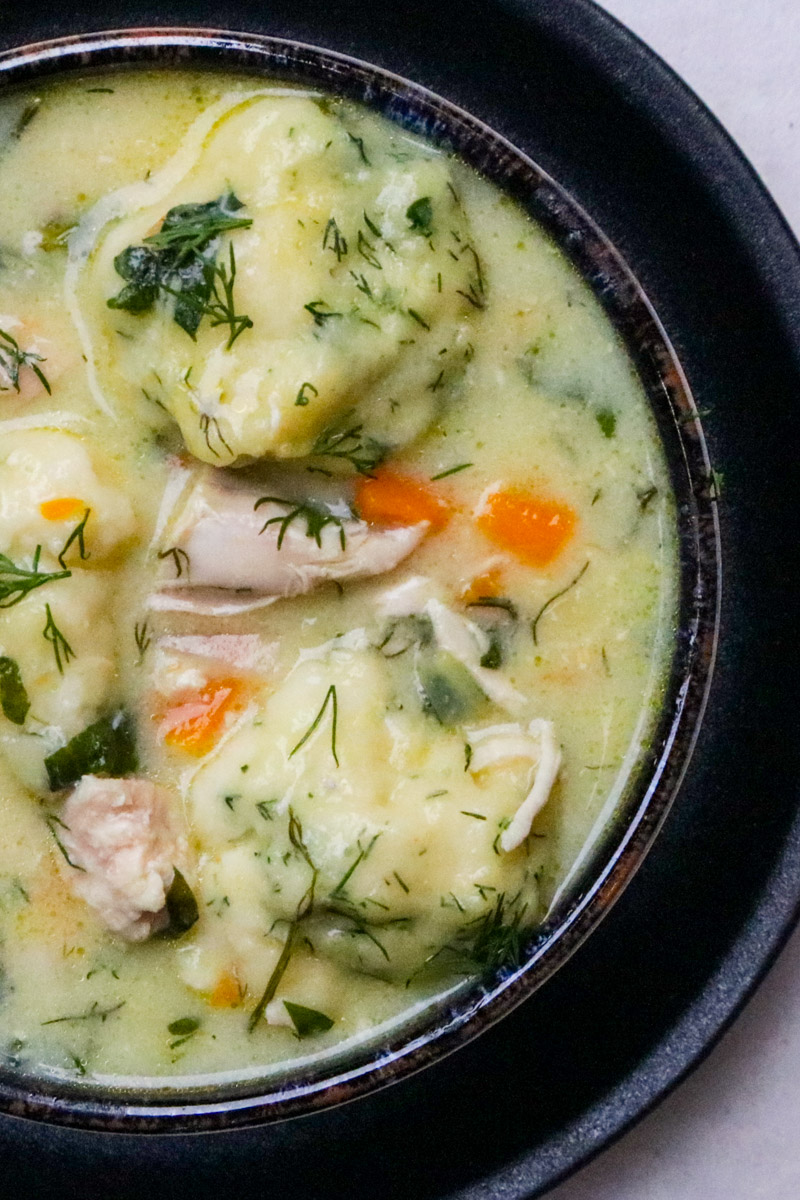 Bowl of chicken and dumpling soup on a table.