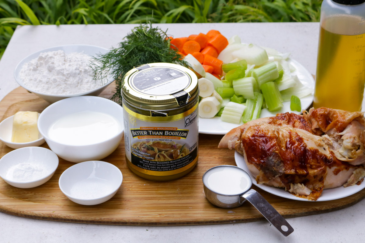 Rotisserie chicken pieces, jar of chicken bouillon, flour, butter, milk, baking powder, salt, oil, dill, celery, carrots, parsnip, onion, cream.