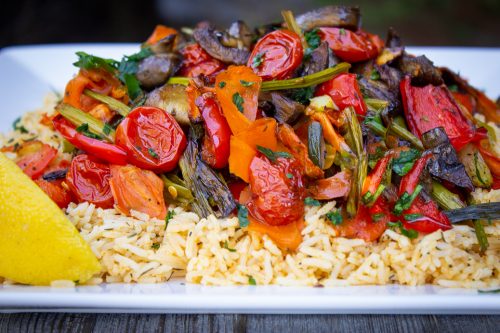 Roasted Veggies on top of Spiced Rice on a plate